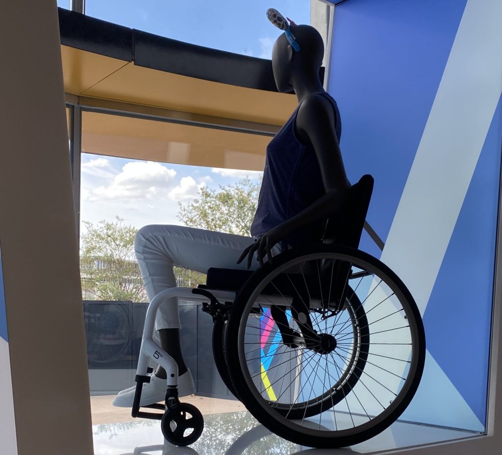 Mannequin seated in wheelchair on display at MouseGear store in EPCOT