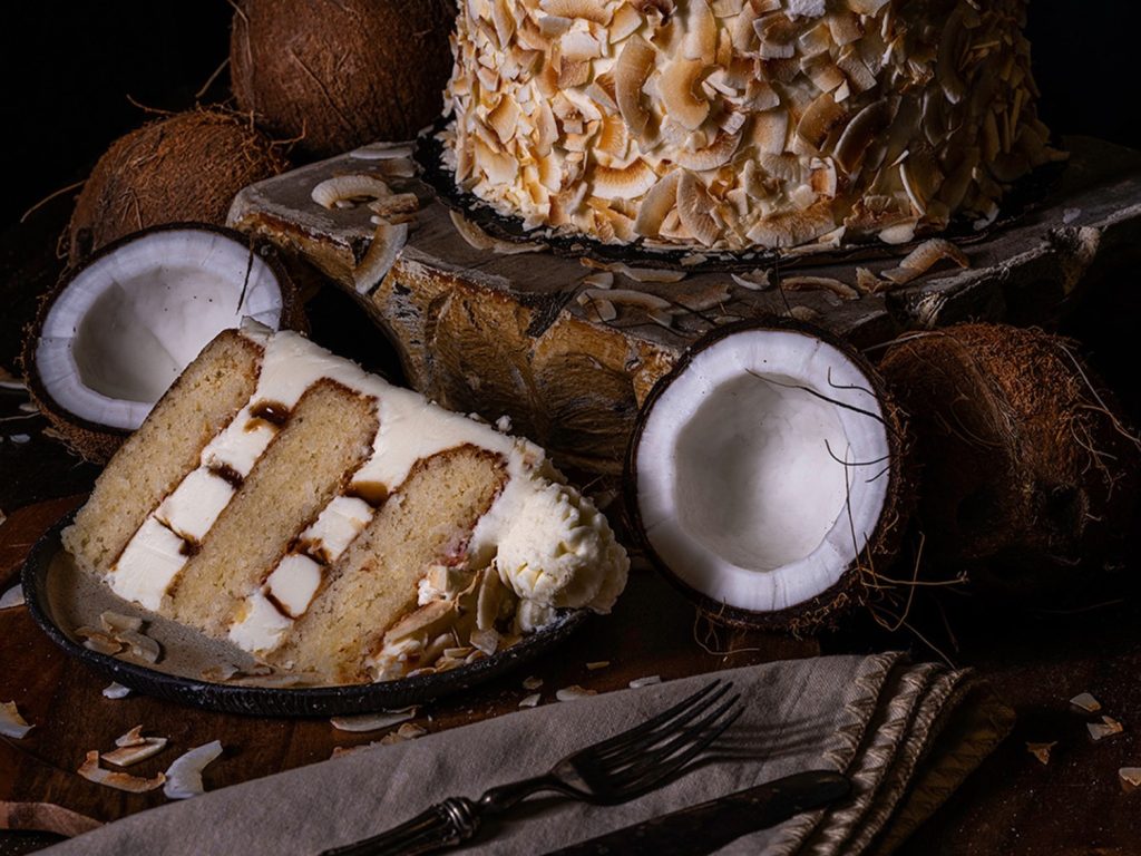 Fan-Favorite Coconut-Cream Cake Returns to Gideon’s Bakehouse at Disney World gideons-bakehouse-coconut-cream-slice-header