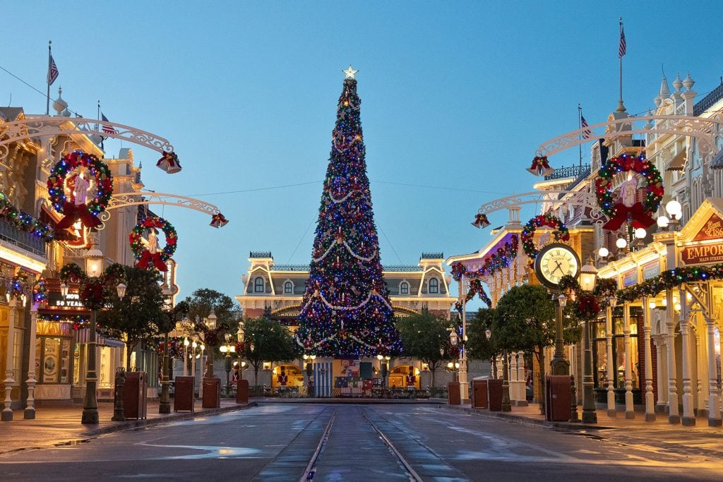 Walt Disney World Holiday Plans to Be Revealed June 24 as New Teasers Hint at Christmas Events magic-kingdom-main-st-christmas-tree-train-station