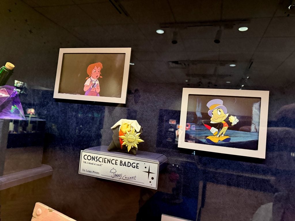 concsience badge | WDWINFO.COM Did You See These Easter Eggs in the Magic of Animation Building? concsience badge